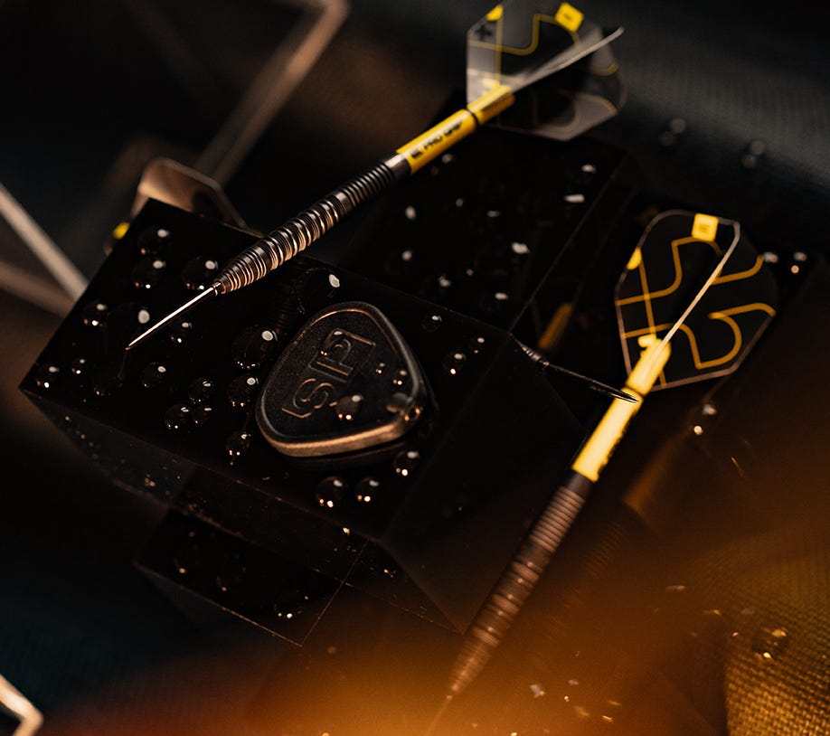 Close-up view of the Bolide Void 01 SP darts and included Swiss Point Tool.