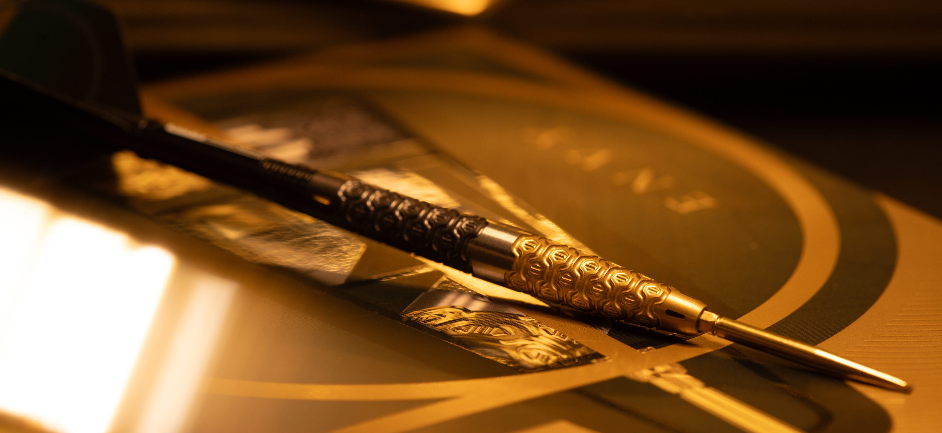 Close-up of the Cult Envy 01 SP steel tip dart laid on a Cult Envy box.