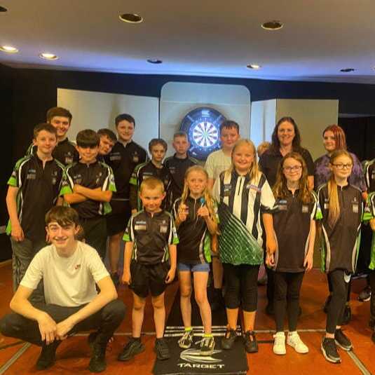 Dart Academy North East youth players standing in front of the oche