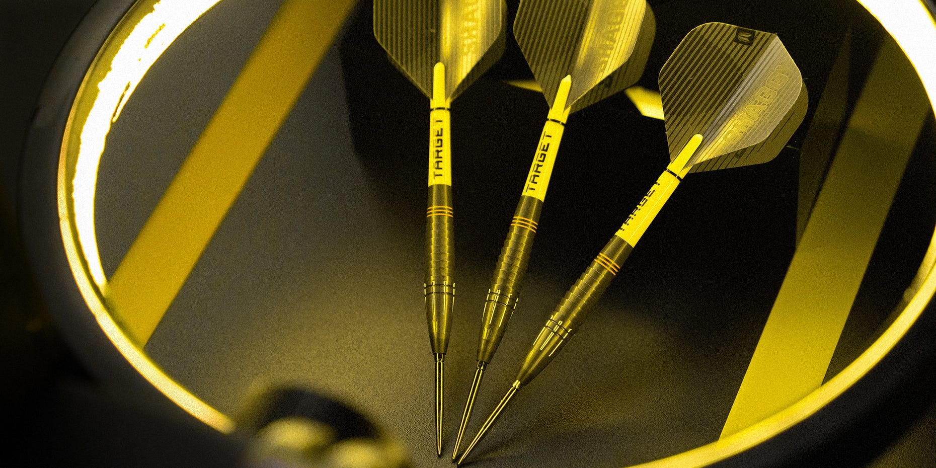 A set of Scott Williams Black steel tip darts laid out.