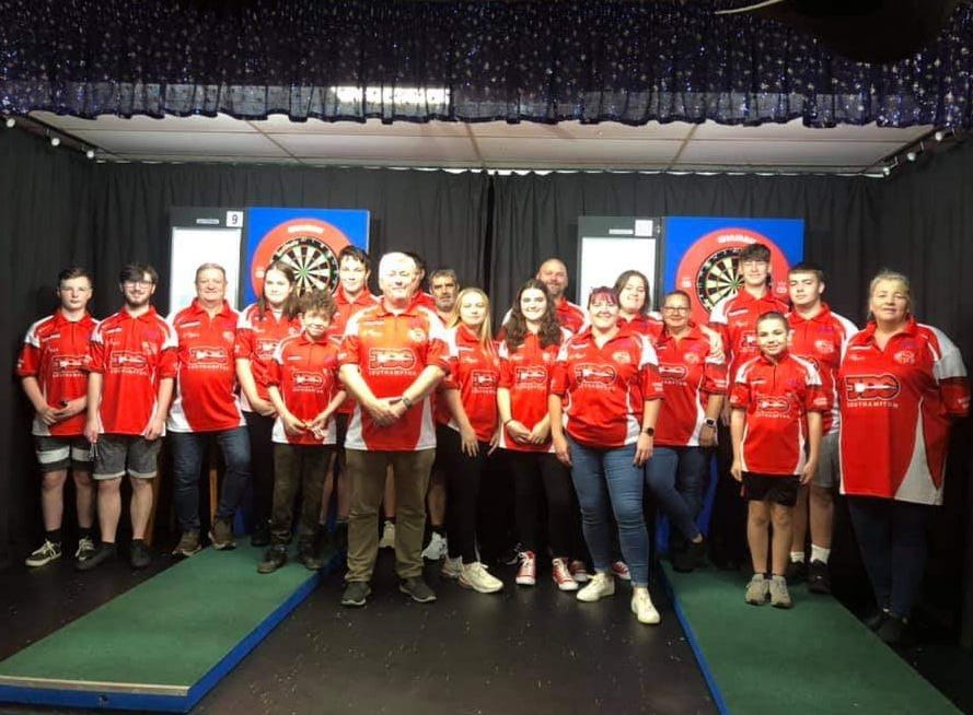 Southampton Junior Darts Academy players standing in front of their oche