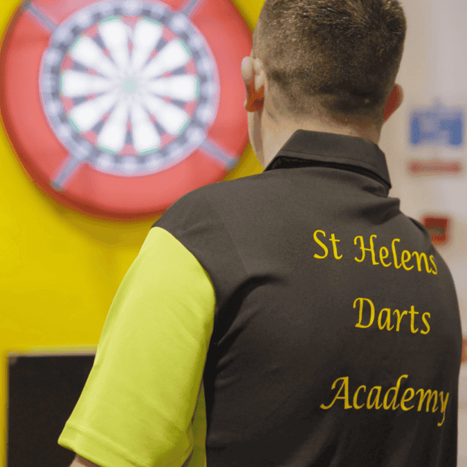 St Helens Youth Darts Academy player throwing a dart at a dartboard