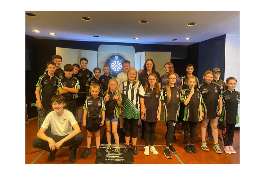 Darts Academy North East players celebrate with Lorraine Winstanley after becoming an Elite 1 affiliated academy