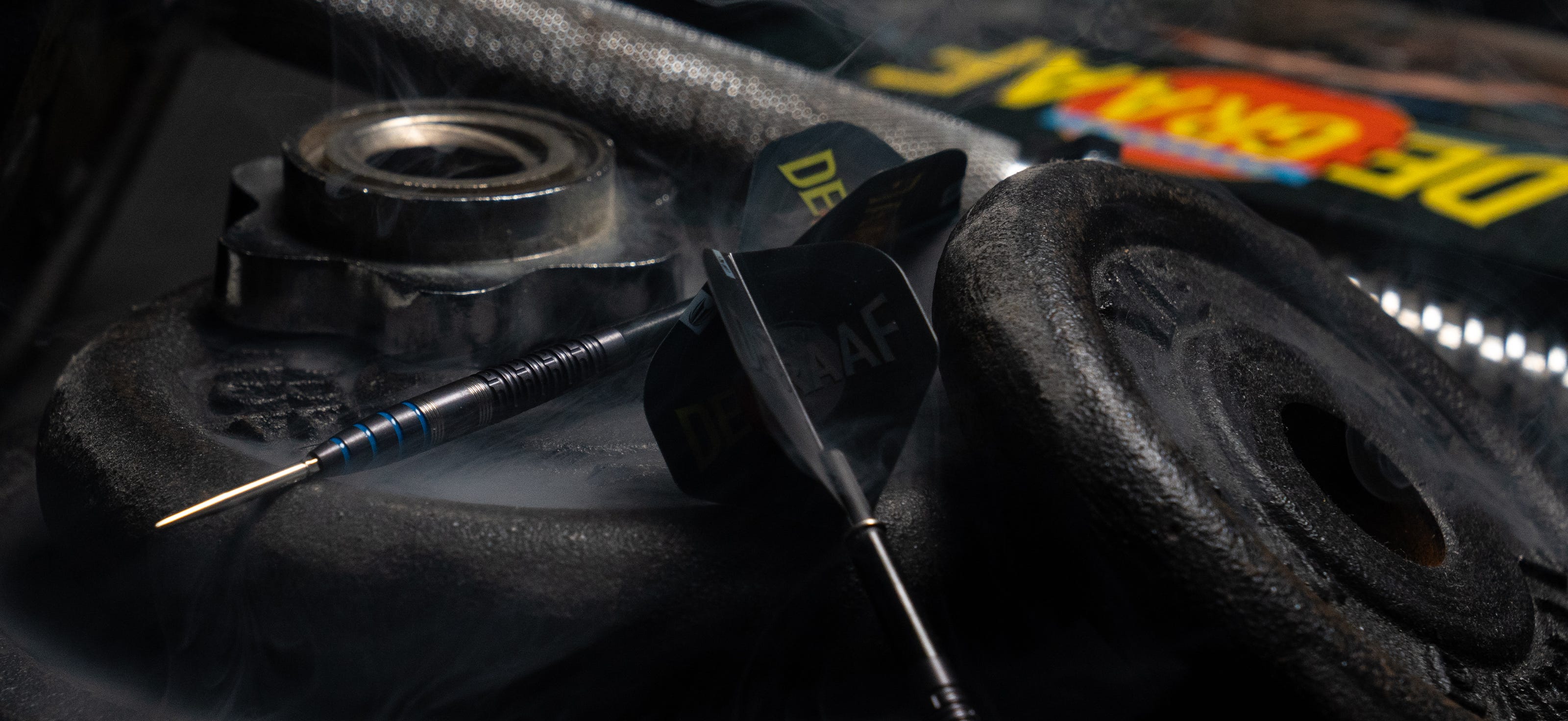 Full view of Jeffrey de Graaf G1 Steel Tip Darts set on top of weights